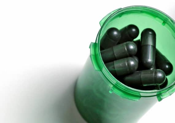 black pills in green bottle