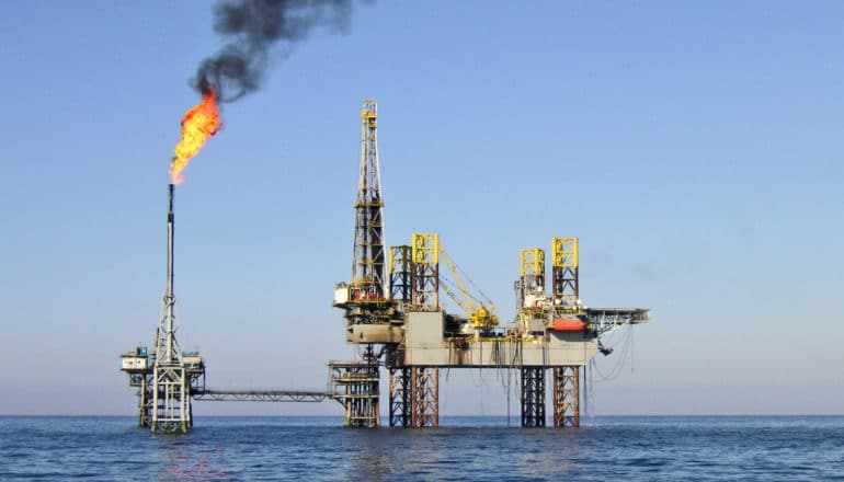 oil platform with burning plume from tower