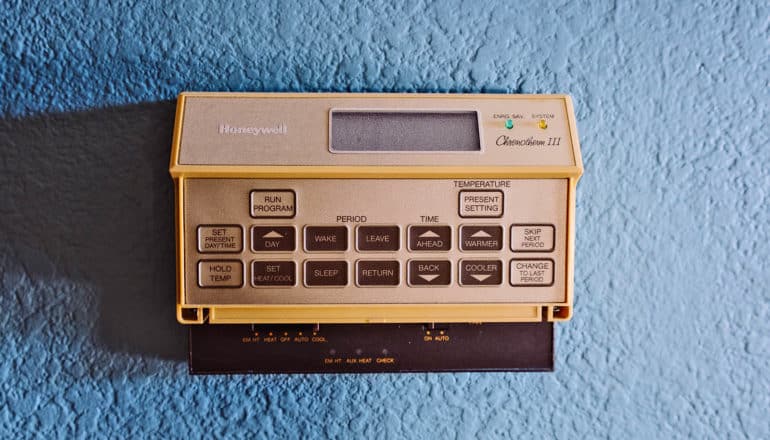 retro thermostat on blue wall