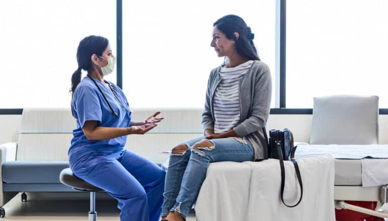 health care provider speaks with patient