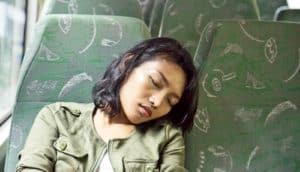woman naps on bus
