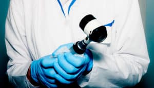 dermatologist holds dermatoscope