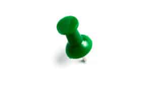 green thumbtack on white