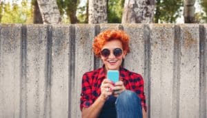 smiling woman uses phone