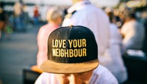 hat says "love your neighbor"