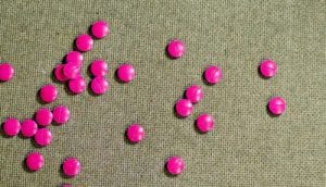 pink pills on wood
