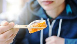 woman eats sushi
