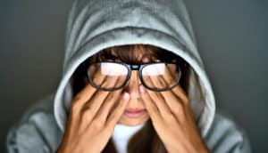 tired girl rubs eyes