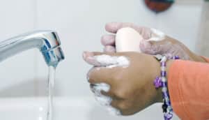 child washes her hands