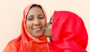 muslim mom and daughter in red