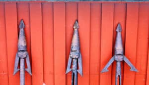 harpoons on red wall