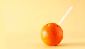 straw stuck into an orange