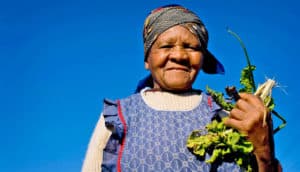 woman holds up greens