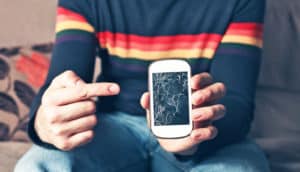 man points at broken phone