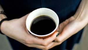 hands hold coffee cup