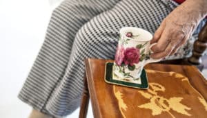 woman holds floral coffee cup