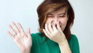 woman pinches her nose