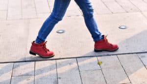 walking in red boots on sidewalk
