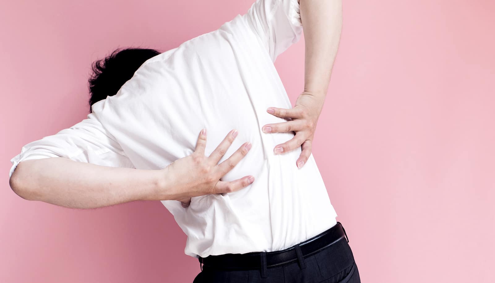 Man holding his back in pain (prednisone side effects concept)