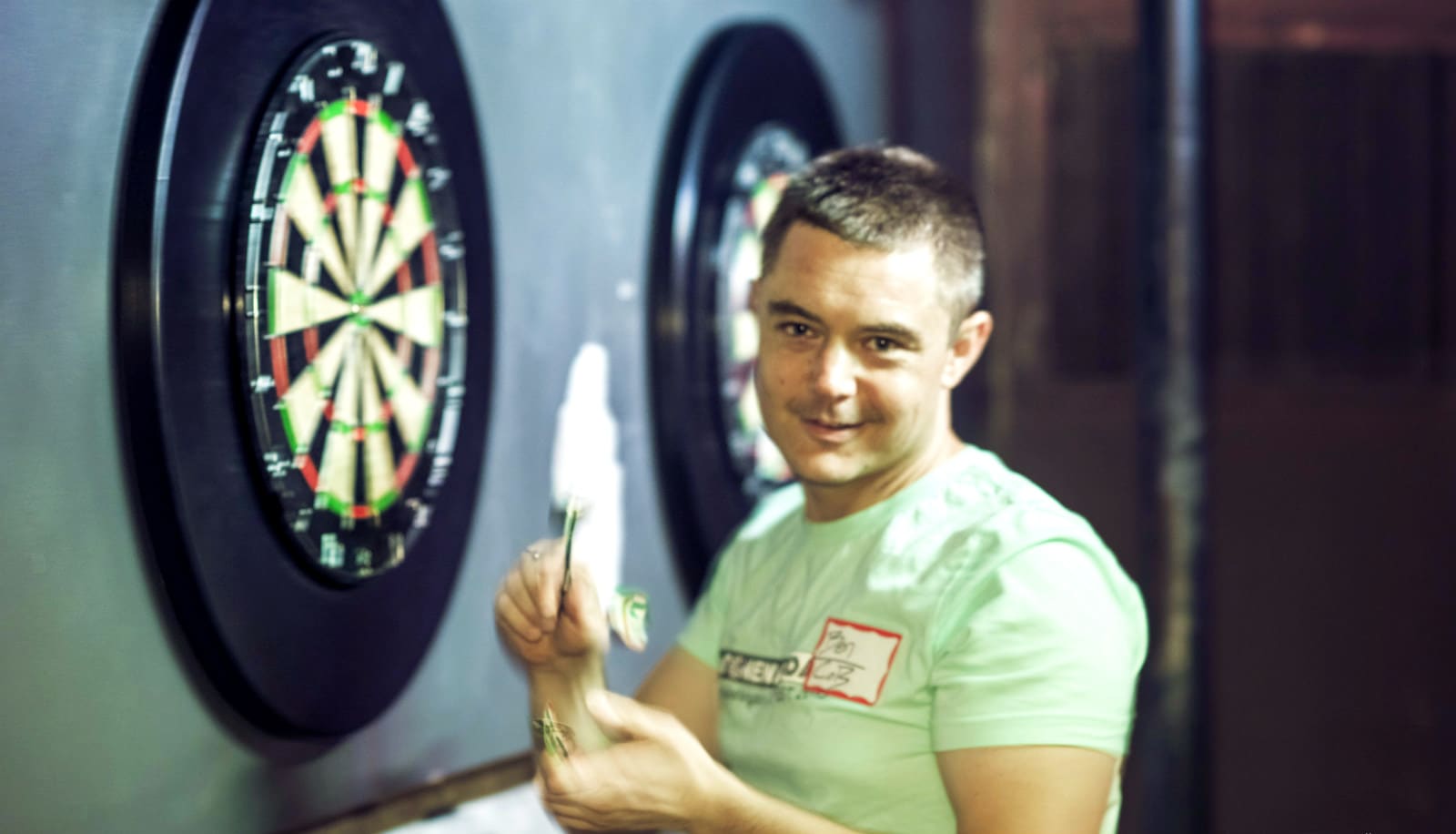 man plays darts
