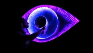 eye in purple lights on black
