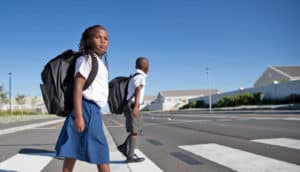 two children cross the street