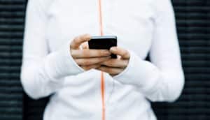 person in white holds phone