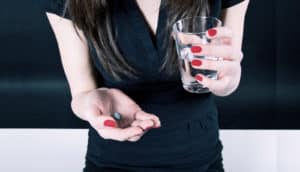 holding antidepressants and water