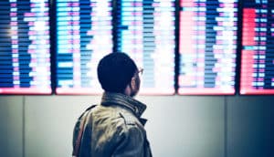 man checks flight times