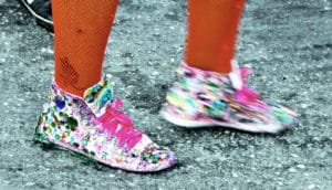 woman wearing bejeweled shoes and orange fishnets