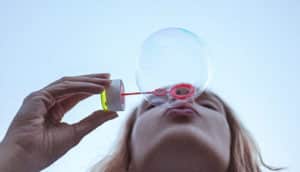woman blowing bubbles