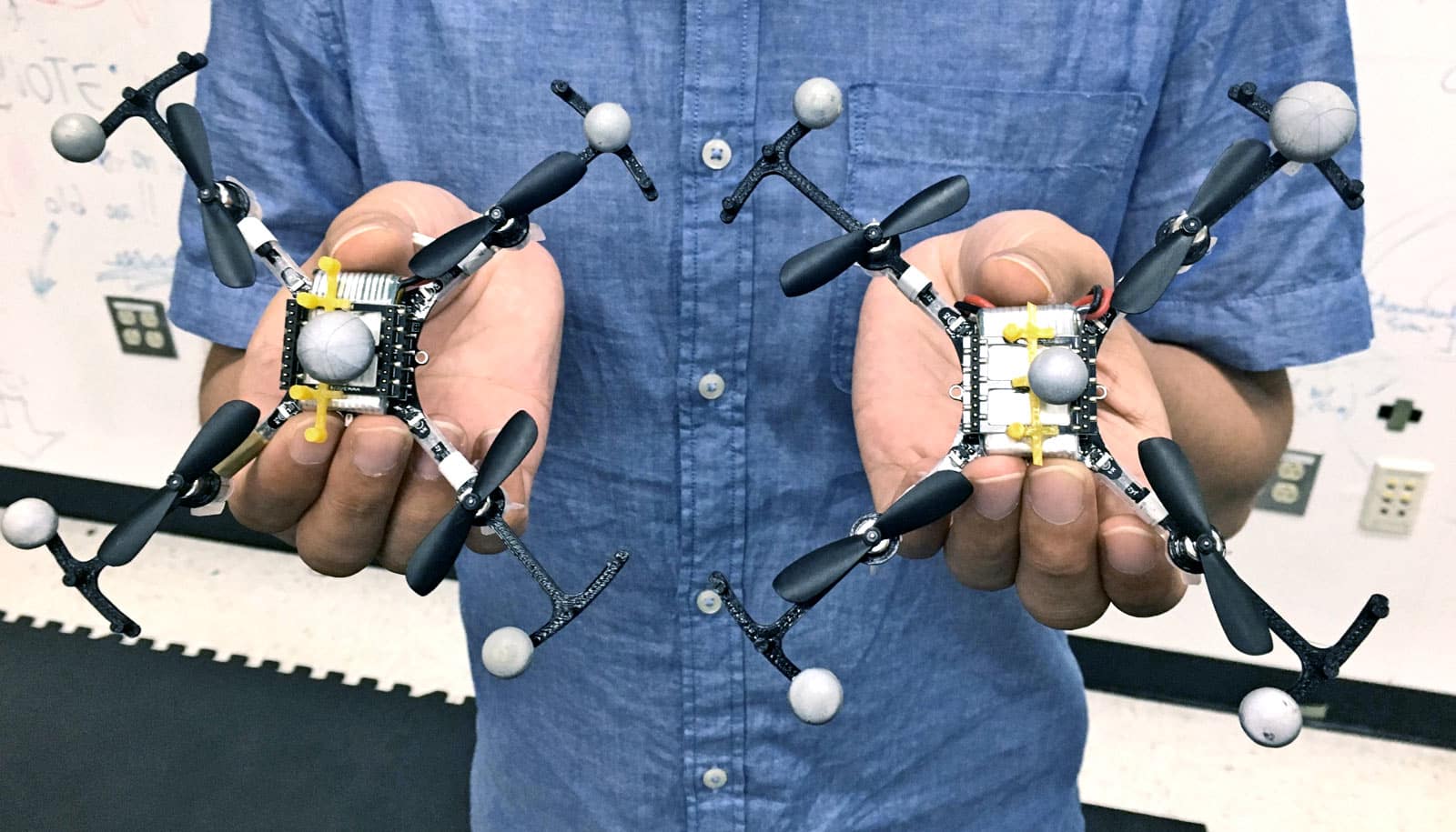 hands hold flying robots