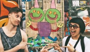 man and woman point at each other