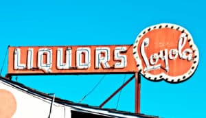 liquor store sign on blue sky