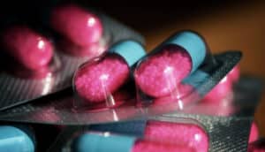 pink and blue capsule pills