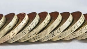 leaning row of pound coins