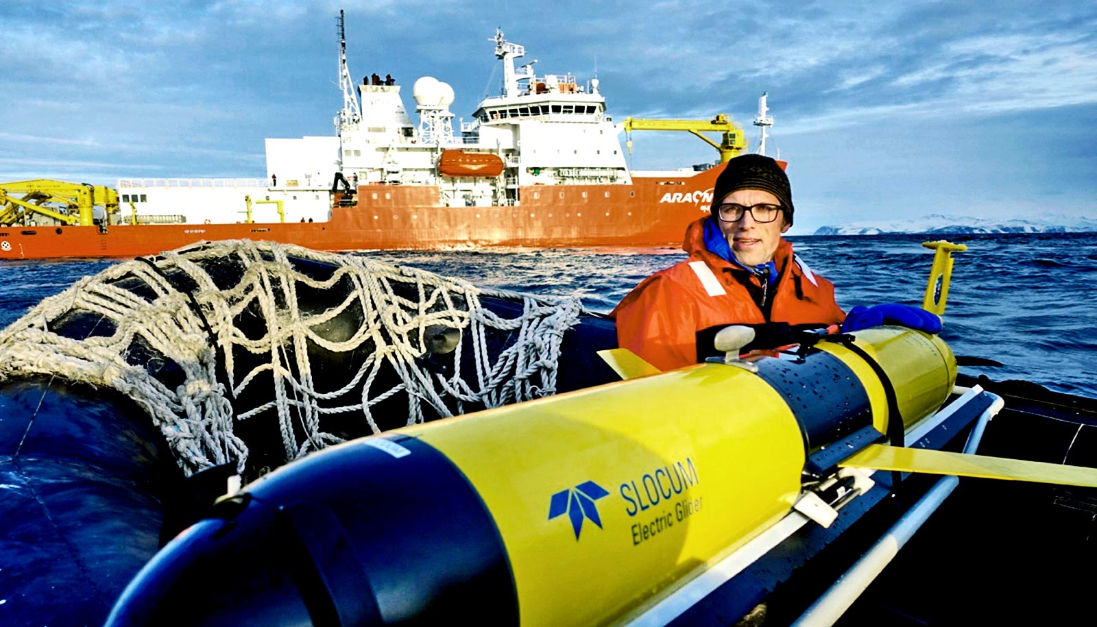 researcher with robot on boat