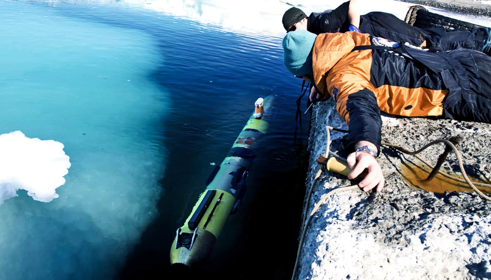 researchers look over the cliff at