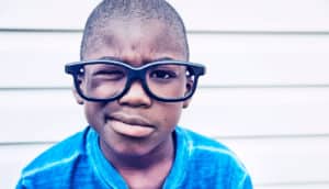 skeptical child in glasses