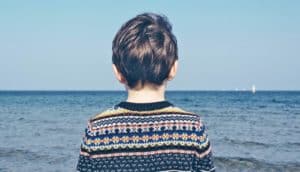 child staring out at sea