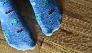 blue frog socks on wood floor