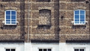 center of three windows is bricked over