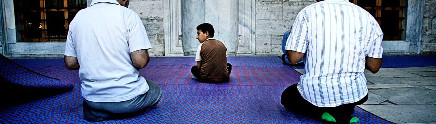 praying men and child in mosque