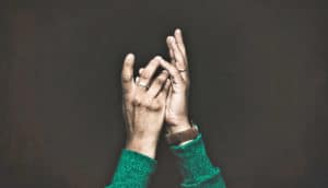 raised hands on black