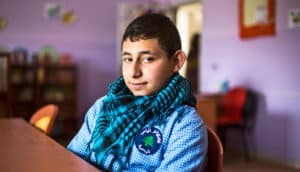 syrian teen boy at desk