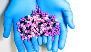 hands in blue gloves hold PPIs