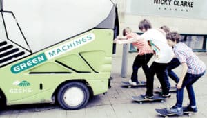 kids on skateboards hitch a ride