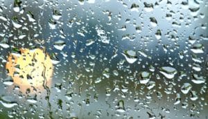 moon behind wet glass