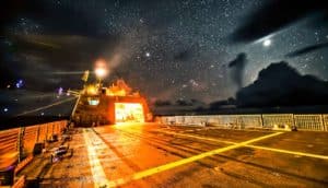 Naval ship under stars at night