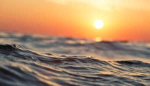 sun over ocean water